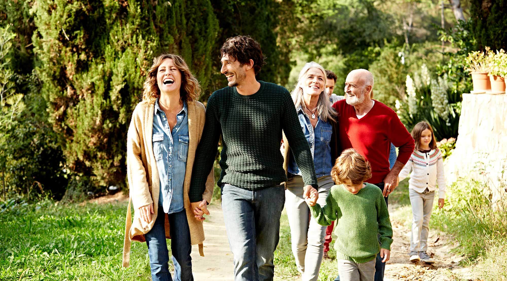 Multi-generational family walking in the park
